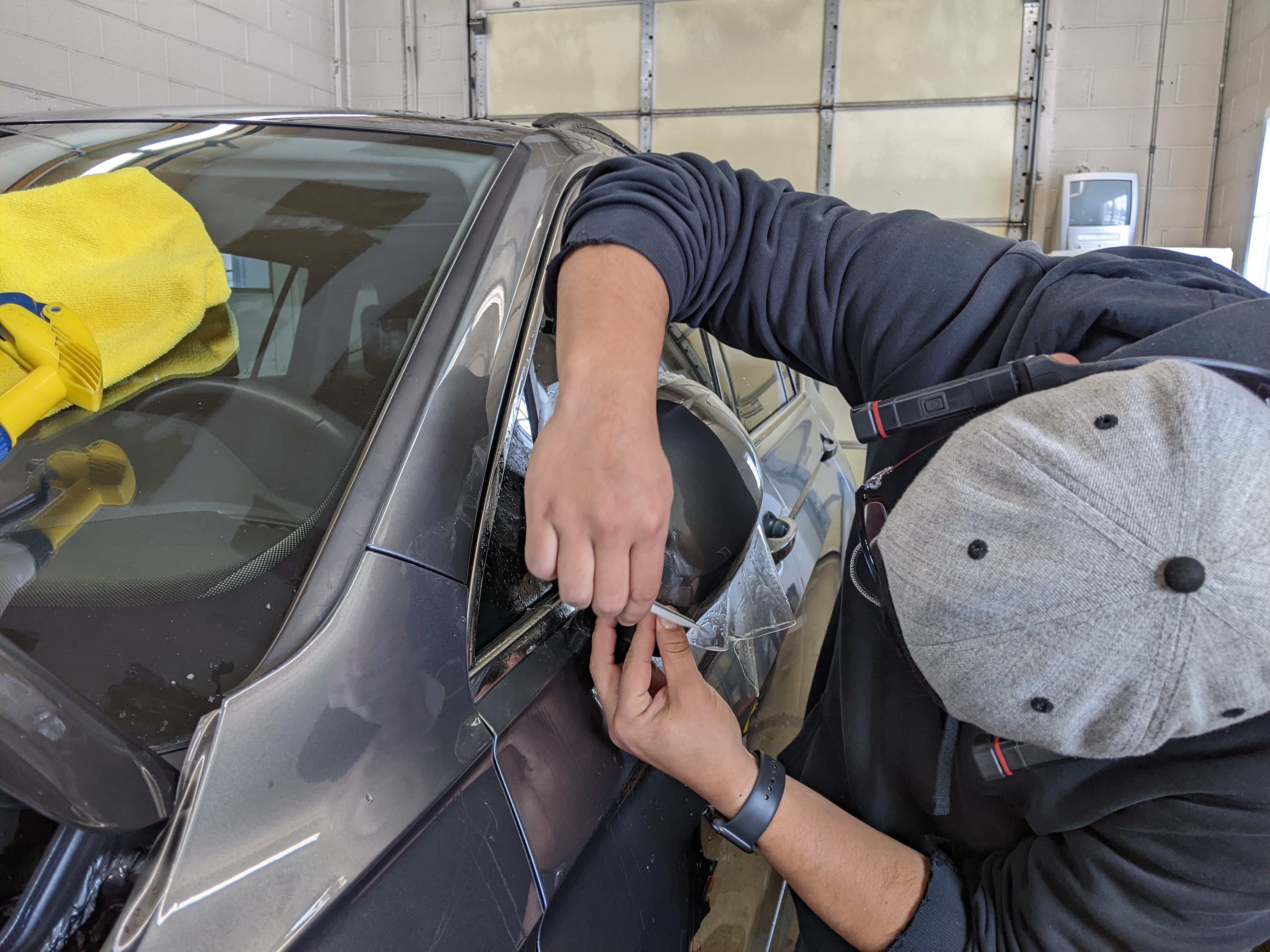 2019 Volkswagen Tiguan bulk mirror clear bra getting installed.