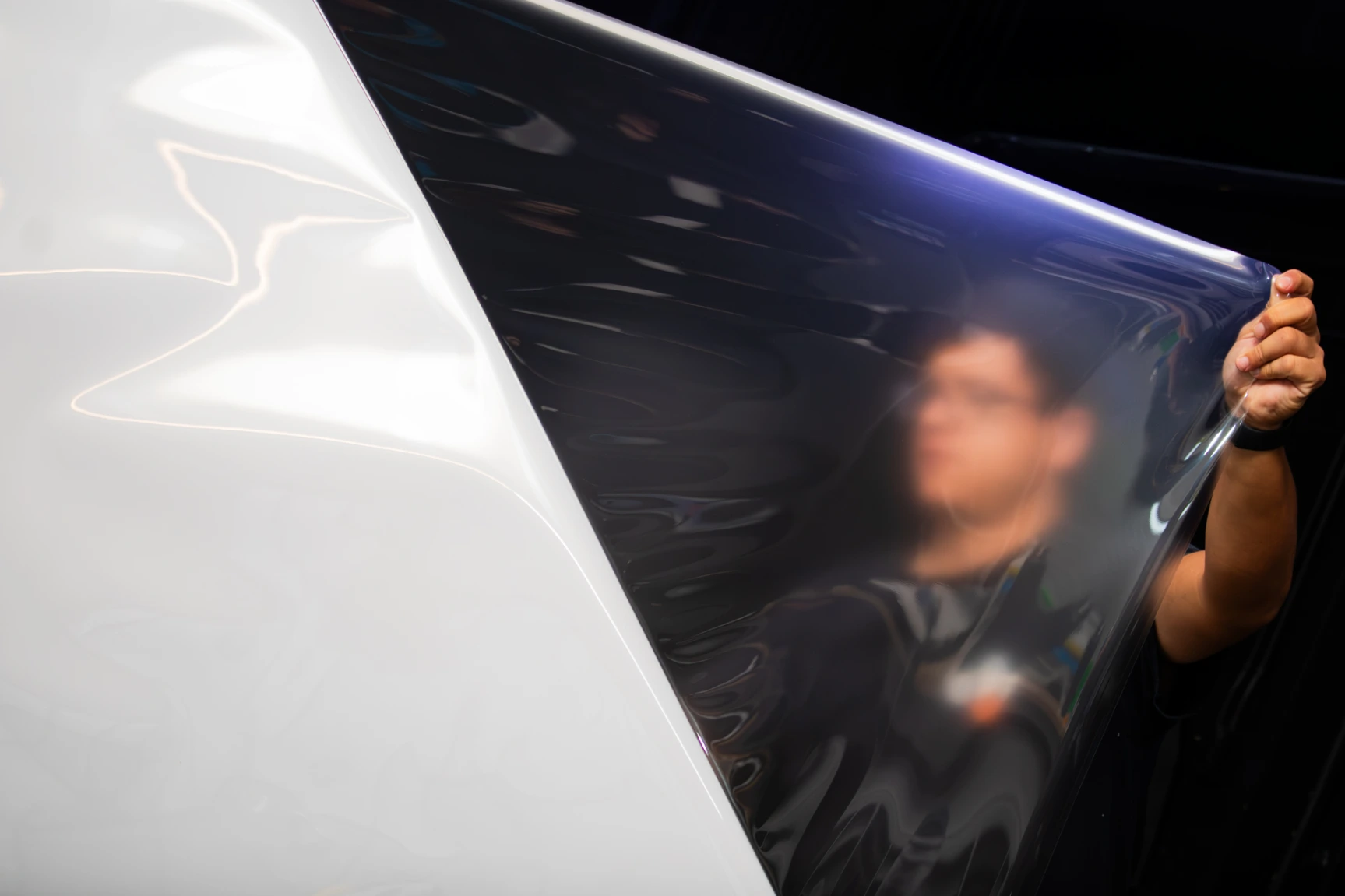 Clear bra PPF installer stretching fresh PPF