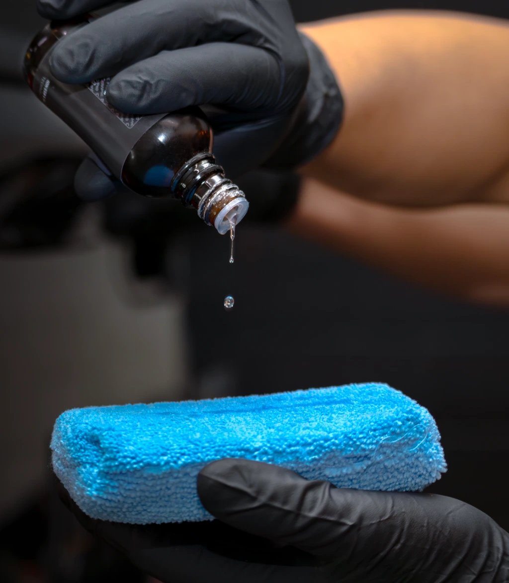 Applying Ceramic Pro coating to an applicator sponge at Pro-Tech Auto Shield in Wheat Ridge
