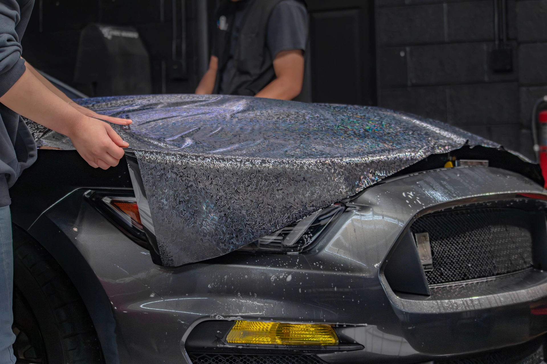 Professionals installing color PPF on 2018 Ford Shelby GT350 hood
