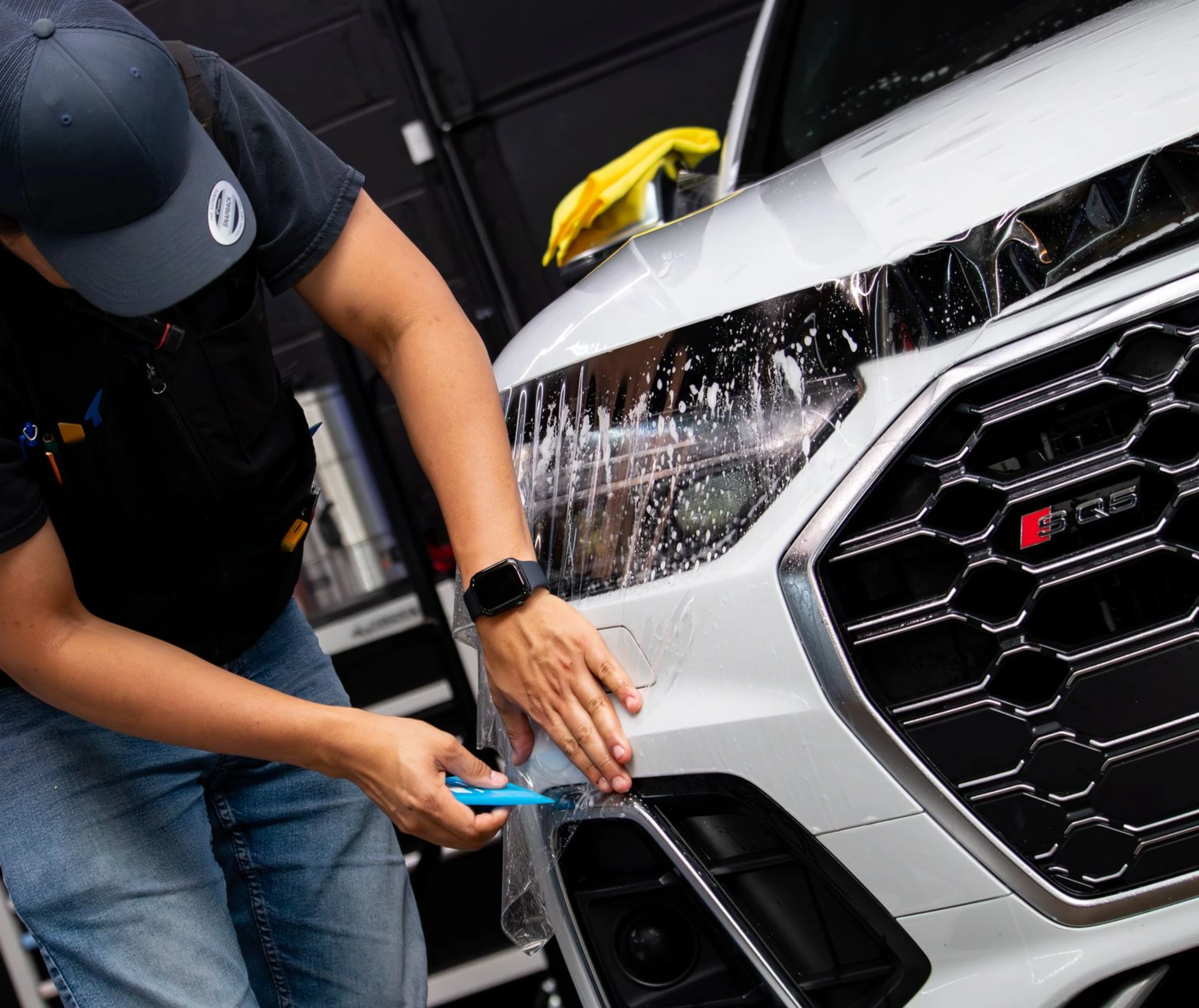 Professional installation of clear bra a 2025 BMW X5 M Competition hood at Pro-Tech Auto Shield in Wheat Ridge