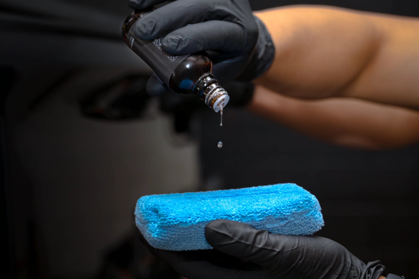 Applying Ceramic Pro coating to an applicator sponge at Pro-Tech Auto Shield in Wheat Ridge