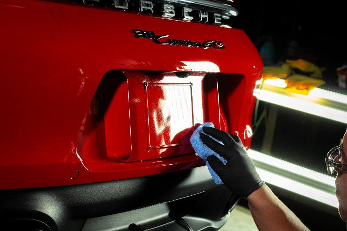 Applying Fusion Plus Ceramic Coating Premium V2 to 2024 Porsche 911 Carrera GTS back bumper at Pro-Tech Auto Shield in Wheat Ridge