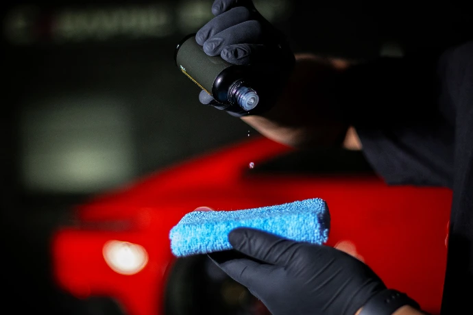 Applying Fusion Plus Ceramic Coating Premium V2 to an applicator sponge at Pro-Tech Auto Shield in Wheat Ridge