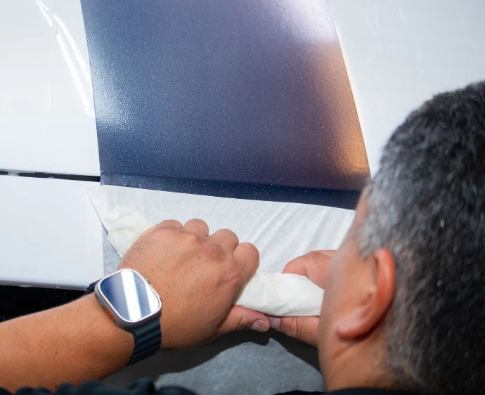 Installation of custom vinyl racing stripes on a Ford Mustang hood at Pro-Tech Auto Shield in Wheat Ridge