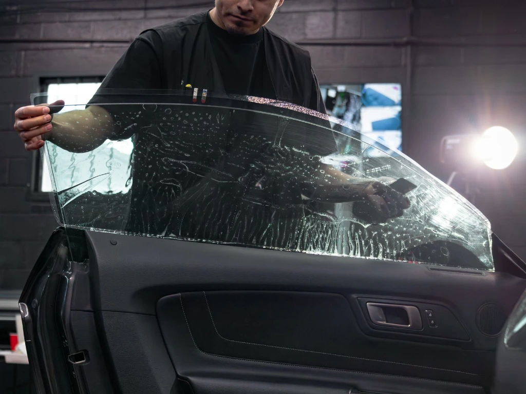 Professional ceramic window tint installation on 2018 Ford Shelby GT350 window for heat and glare reduction at Pro-Tech Auto Shield in Wheat Ridge
