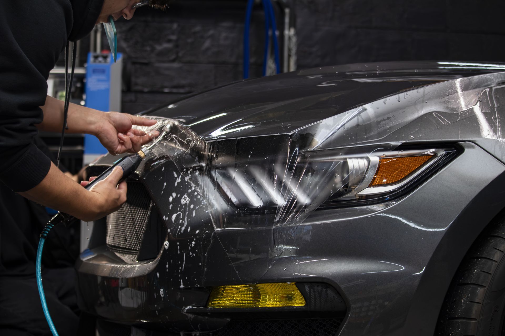 Professional installation of clear bra PPF on a 2018 Ford Shelby Mustang GT350 hood at Pro-Tech Auto Shield in Wheat Ridge