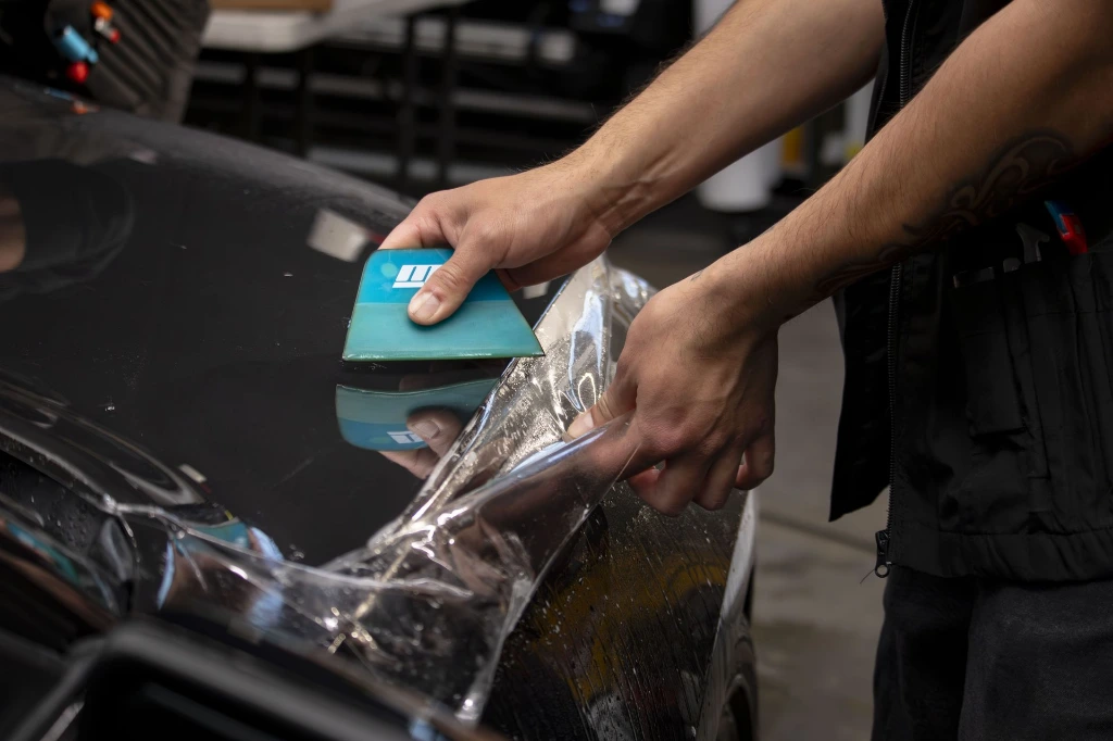 Professional installation of clear bra PPF on a 2018 Ford Shelby GT350 fender at Pro-Tech Auto Shield in Wheat Ridge