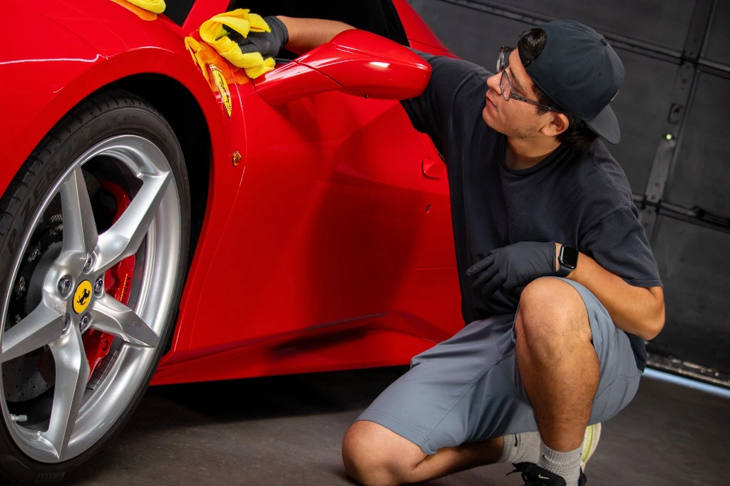 Professional application of ceramic coating on a 2018 Ferrari 488 Spider fender at Pro-Tech Auto Shield