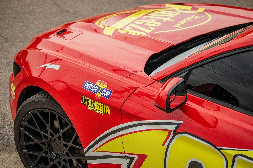 The top fender of a 2018 Ford Mustang EcoBoost Coupe with Lightning McQueen style vinyl decals