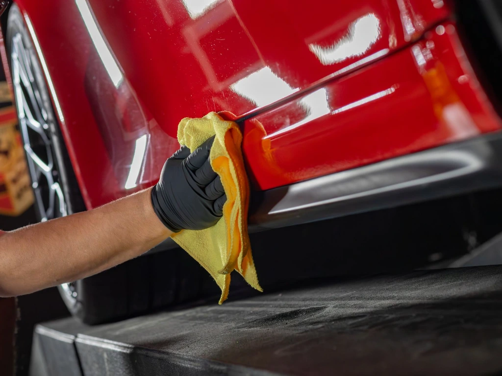 Professional ceramic coating installer applying Fusion Plus Ceramic Coating Premium V2 to 2024 Porsche 911 Carrera GTS rocker panel