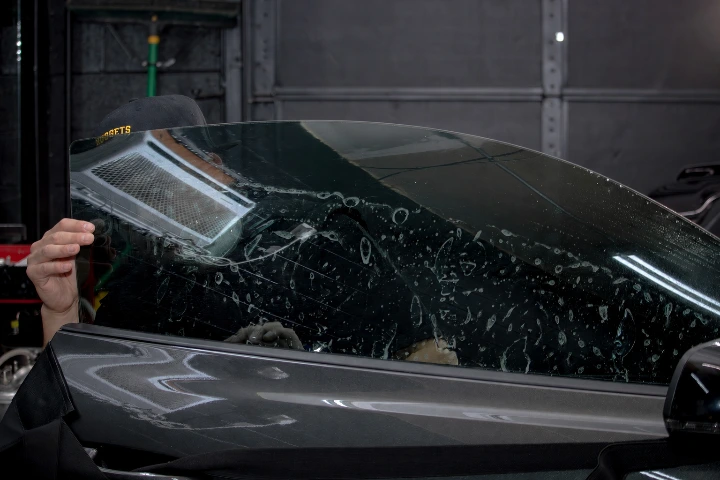 Installer lining up film before finishing the install of the window film