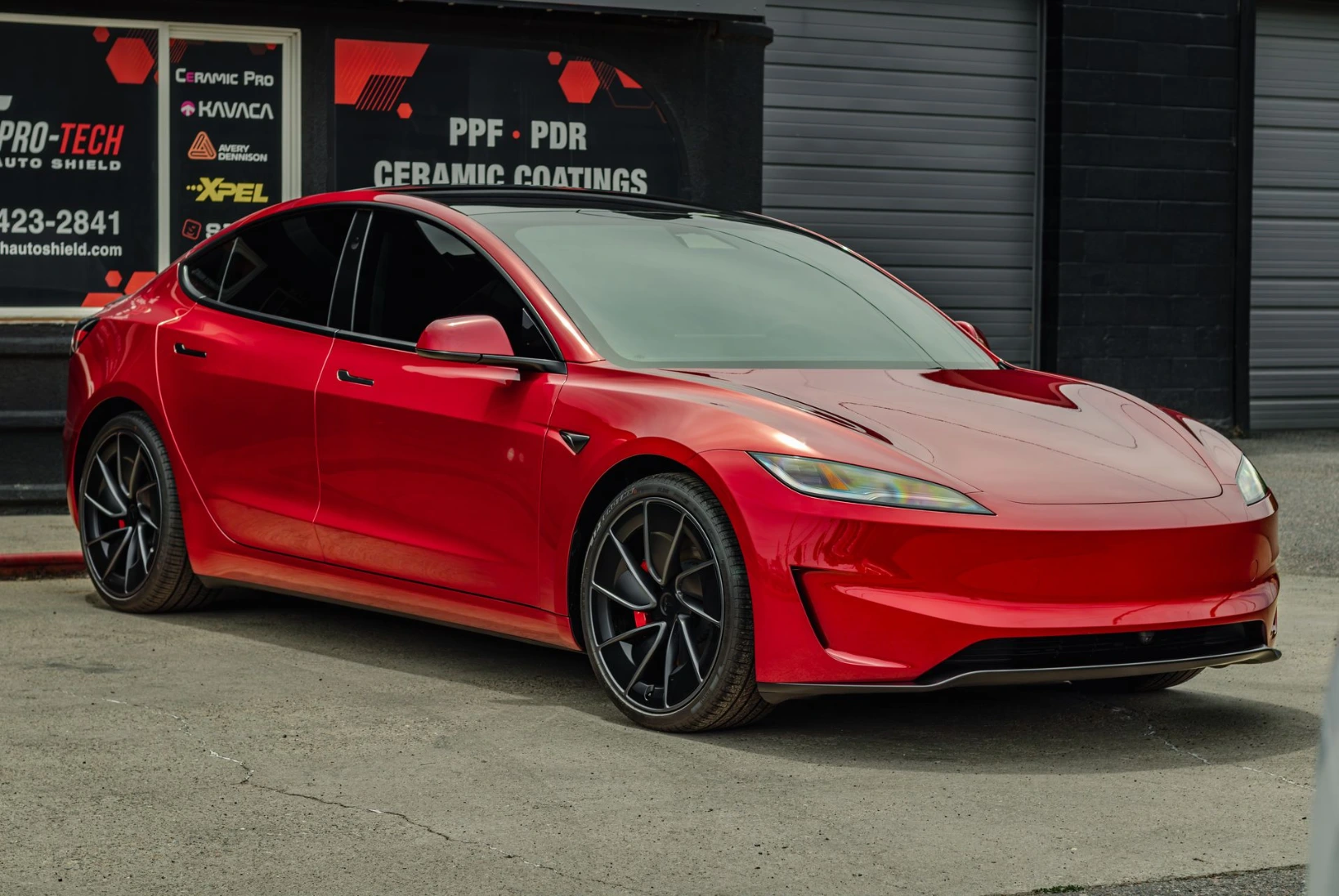 After picture of red tesla with window tint done parked in front of Pro-Tech Auto Shield