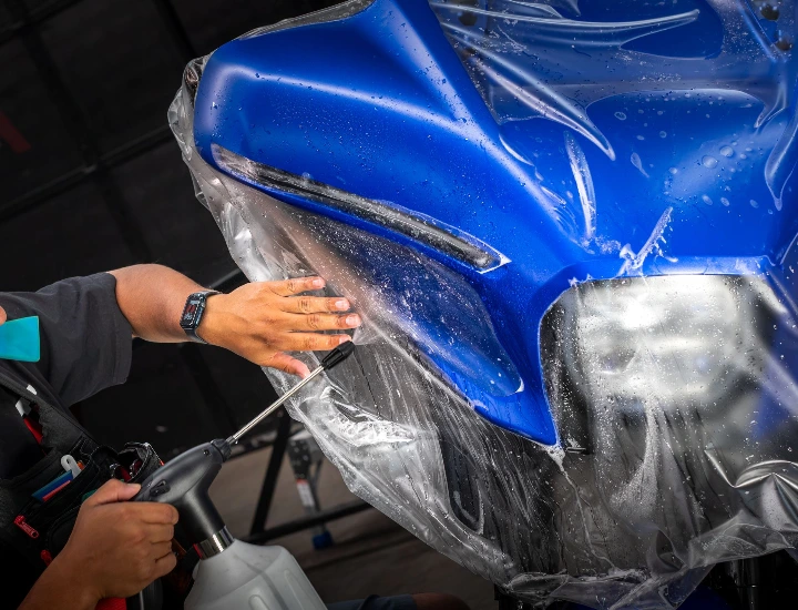 PPF installation on a Harley-Davidson blue motorcycle matte finish