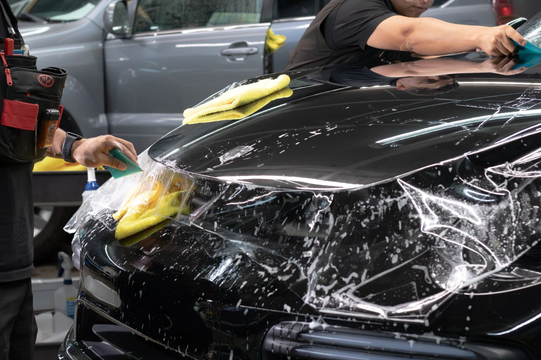 Precise clear bra installation on a flat black Porsche