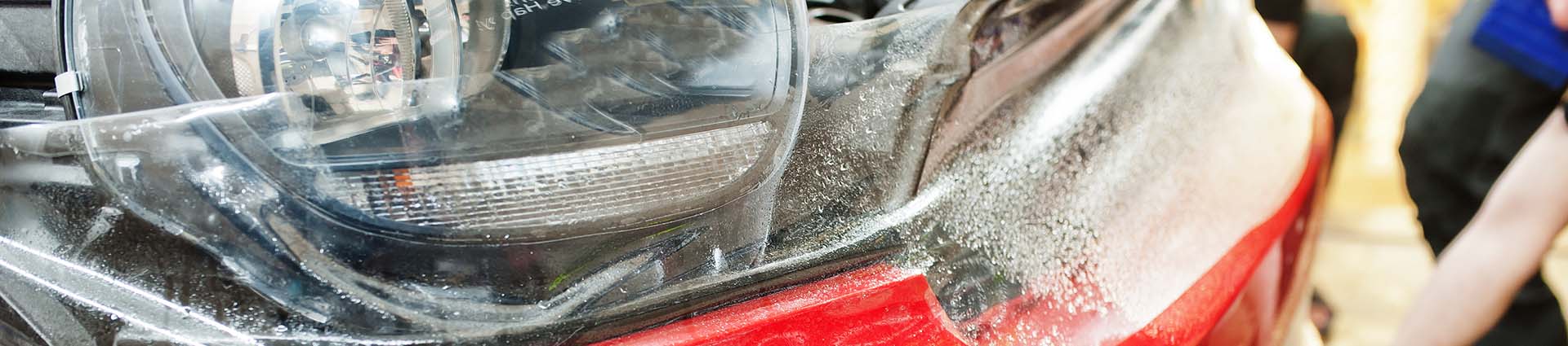 car-service-worker-applying-clear-bra-with-special-films