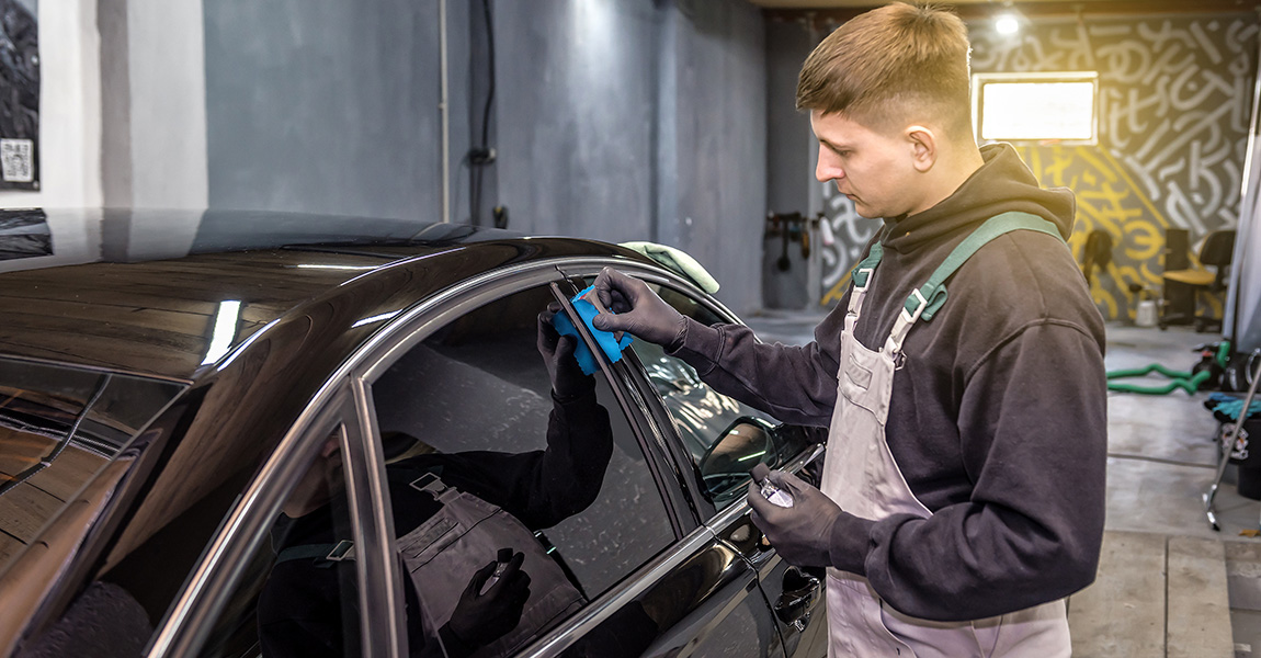 ceramic coating worker applying ceramic coating to a car